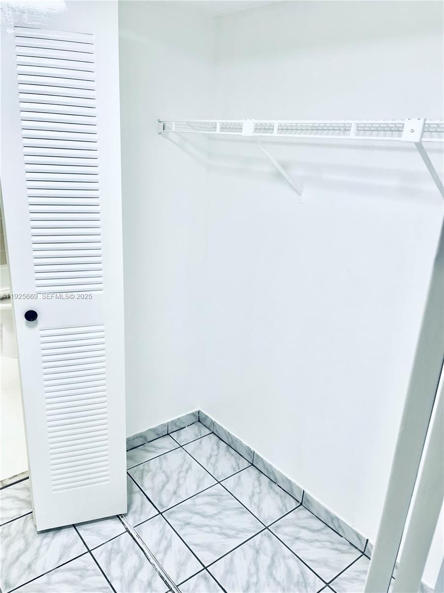 6801 Harding Avenue, Unit 306 Miami Beach, FL 33141 - Photo 27 of 30 a view of a room with racks on the wall