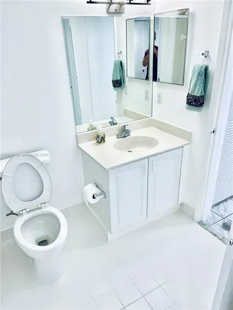 a bathroom with a toilet sink and shower
