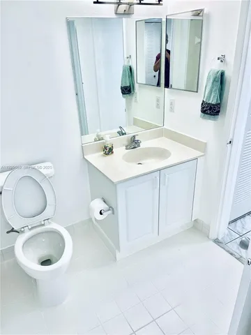 a bathroom with a toilet sink and shower
