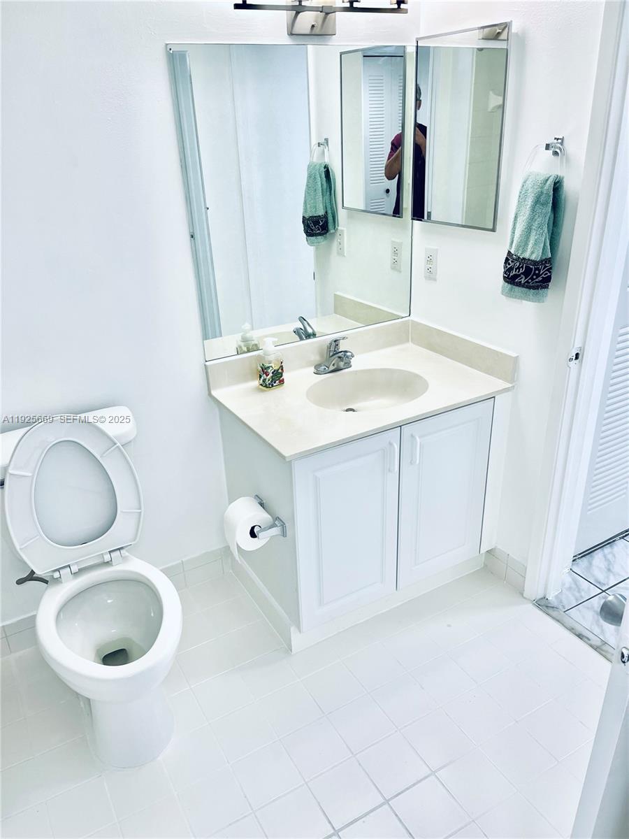 6801 Harding Avenue, Unit 306 Miami Beach, FL 33141 - Photo 10 of 30 a bathroom with a sink and a mirror