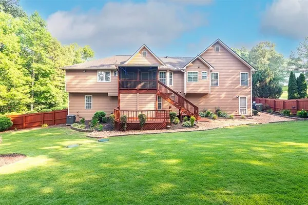 a view of a house with a yard and sitting area
