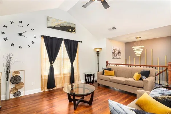 a view of a hallway with wooden floor and stairs
