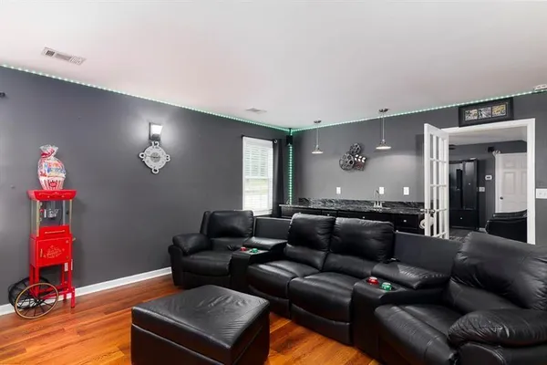 a bedroom with a bed a chandelier and a window