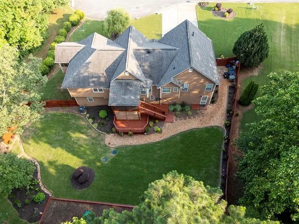 an aerial view of a house with garden space and street view