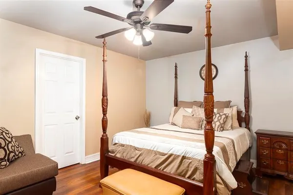 a front view of a house with a yard and trees