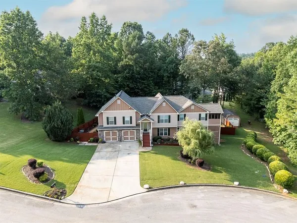 an aerial view of a house with yard swimming pool and outdoor seating