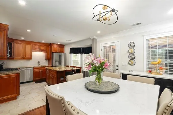 a living room with furniture and kitchen view