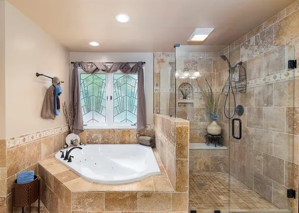 a bathroom with a granite countertop sink a mirror and a shower