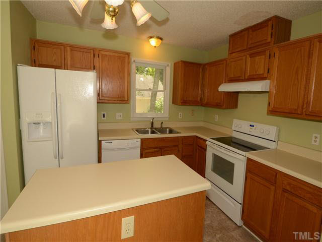 1328 Princess Anne Road Cary, NC 27513 - Photo 5 of 20 a kitchen with stainless steel appliances a stove a refrigerator and a sink