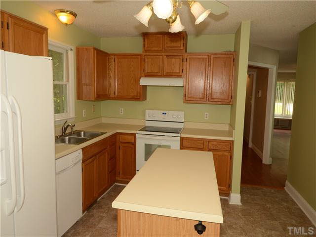 1328 Princess Anne Road Cary, NC 27513 - Photo 6 of 20 a kitchen with a refrigerator sink and cabinets