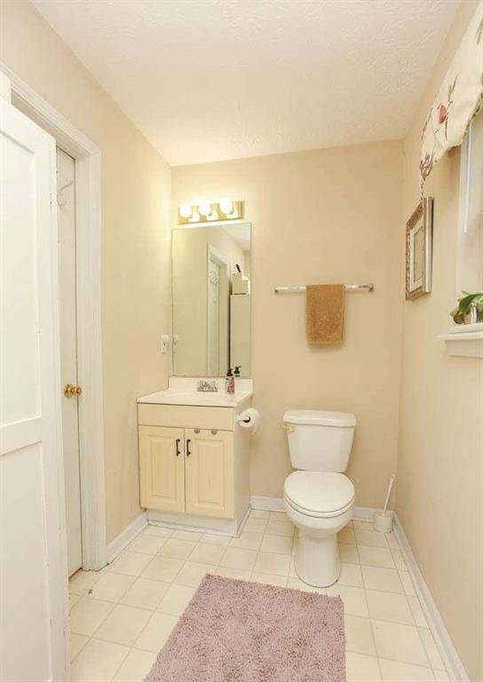 177 Rustin Drive Dallas, GA 30157 - Photo 14 of 26 a spacious bathroom with a toilet sink and mirror