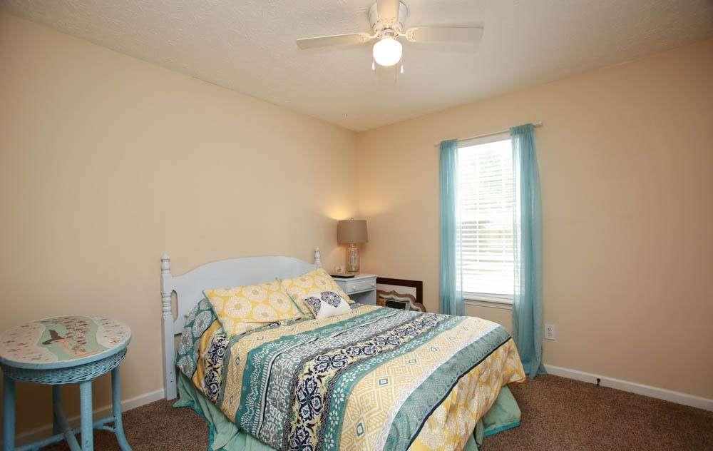 177 Rustin Drive Dallas, GA 30157 - Photo 20 of 26 a bedroom with a bed a chandelier and a window