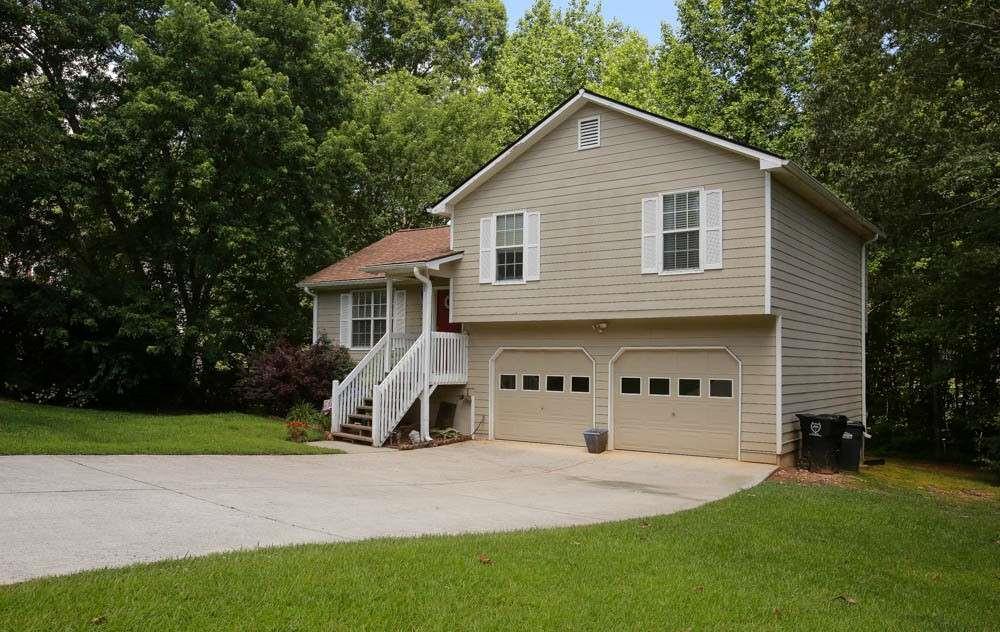 177 Rustin Drive Dallas, GA 30157 - Photo 2 of 26 a view of a house with a yard and garage