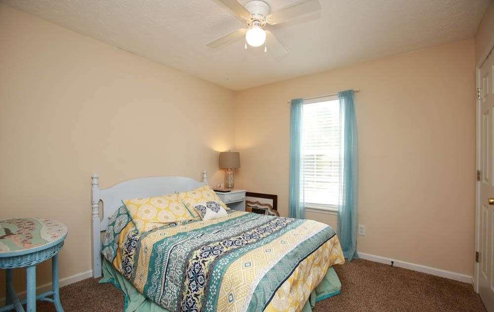 177 Rustin Drive Dallas, GA 30157 - Photo 21 of 26 a bedroom with a bed and a chandelier
