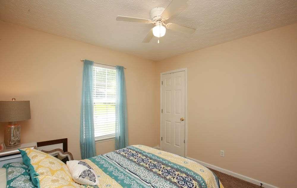 177 Rustin Drive Dallas, GA 30157 - Photo 22 of 26 a bedroom with a bed and a chandelier