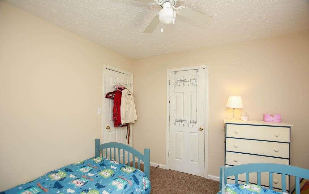 177 Rustin Drive Dallas, GA 30157 - Photo 24 of 26 a bedroom with a bed and a chandelier