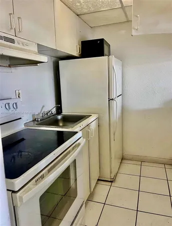 a kitchen with a stove cabinets and a counter top space