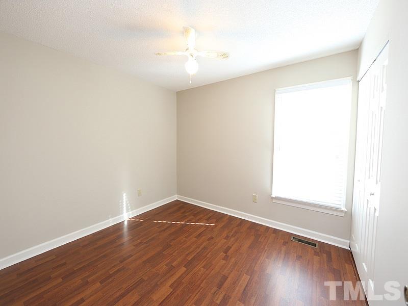 4791 Thomas Road Henderson, NC 27537 - Photo 14 of 25 an empty room with wooden floor and windows