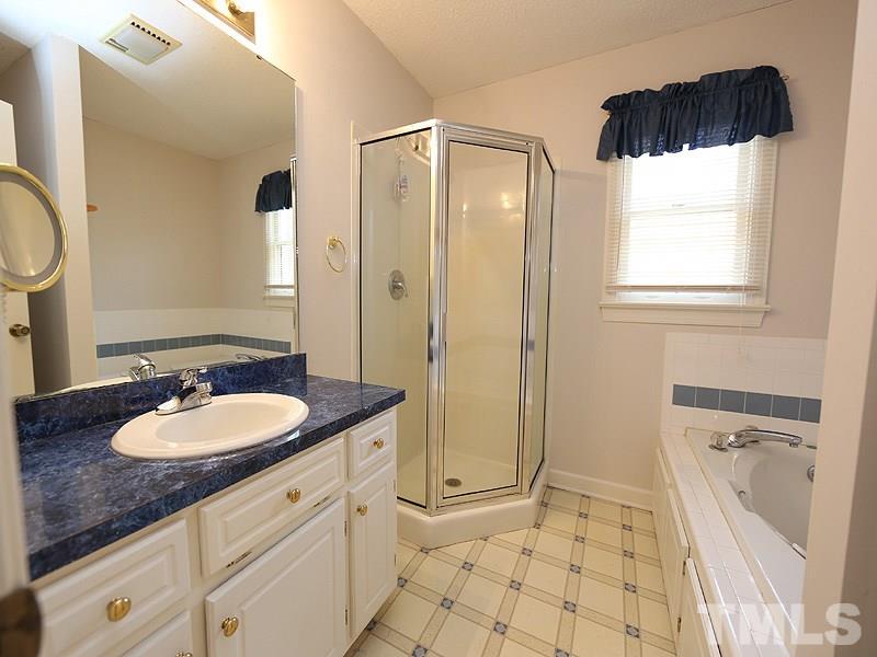 4791 Thomas Road Henderson, NC 27537 - Photo 17 of 25 a bathroom with a granite countertop sink toilet and shower