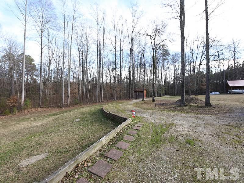 4791 Thomas Road Henderson, NC 27537 - Photo 6 of 25 a backyard of a house with lots of green space