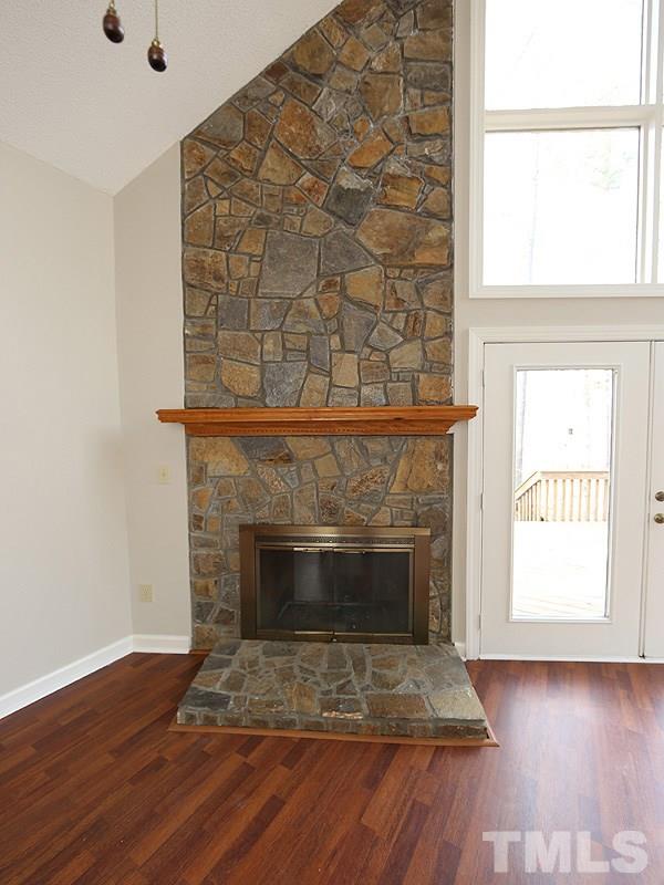 4791 Thomas Road Henderson, NC 27537 - Photo 9 of 25 a living room with a fireplace and a table