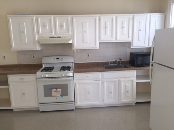 10 Buckley Avenue, Unit 1 Boston, MA 02130 - Photo 10 of 15 a kitchen with white cabinets and white appliances