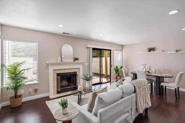 a living room with furniture a fireplace with wooden floor