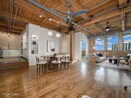 a living room with lots of furniture and a wooden floor
