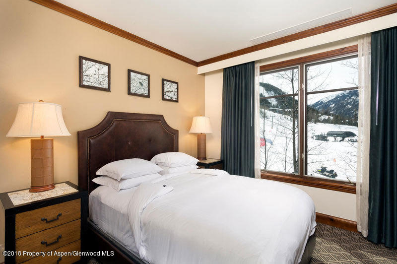 197 Prospector Road, Unit 230612 Aspen, CO 81611 - Photo 21 of 27 a bedroom with a bed and a window