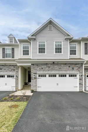 a view of a large white building with a large pool