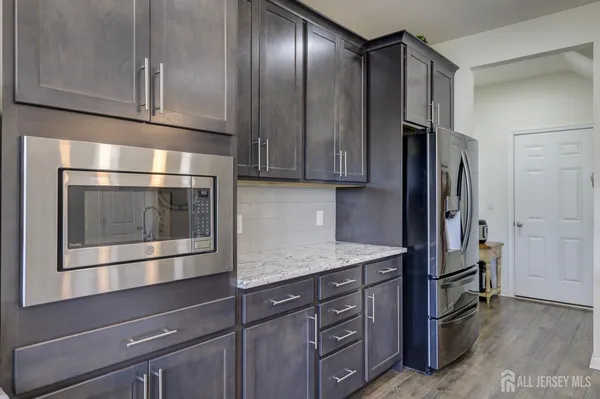 a kitchen with granite countertop stainless steel appliances and wooden cabinets