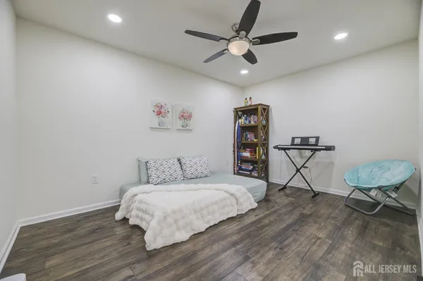 a bedroom with a bed window and a chair