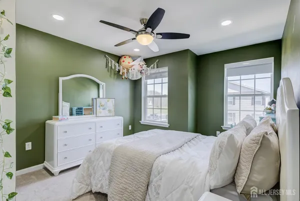 a spacious bedroom with a bed and a chandelier