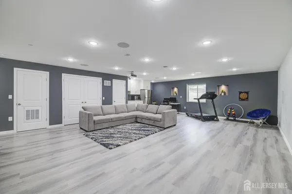 a living room with furniture and a wooden floor