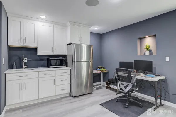 a kitchen with a refrigerator a stove and a cabinets