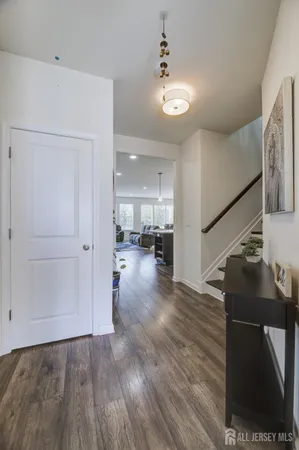 a view of a hallway view with wooden floor and staircase