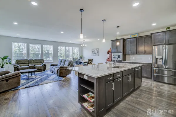 a kitchen with stainless steel appliances granite countertop a stove and a refrigerator