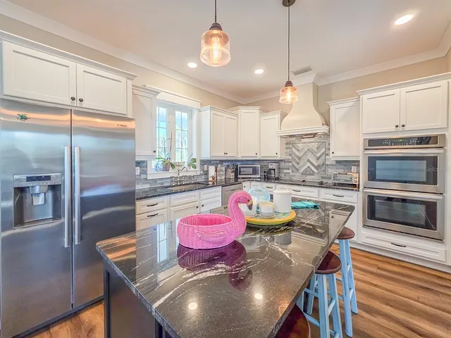 a bathroom with a double vanity sink toilet mirror and bathtub