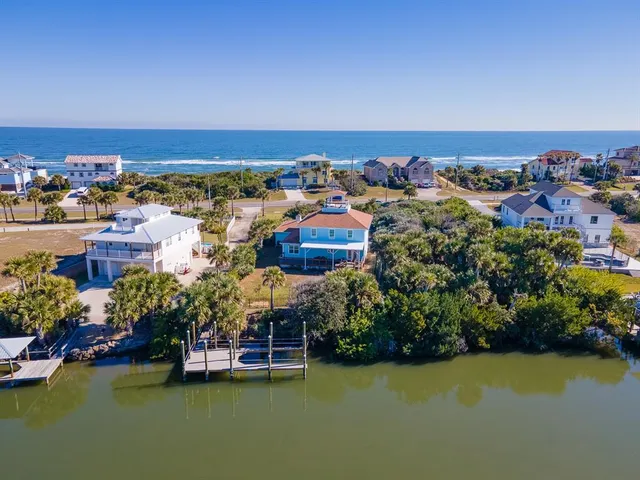 an aerial view of a houses with a swimming pool
