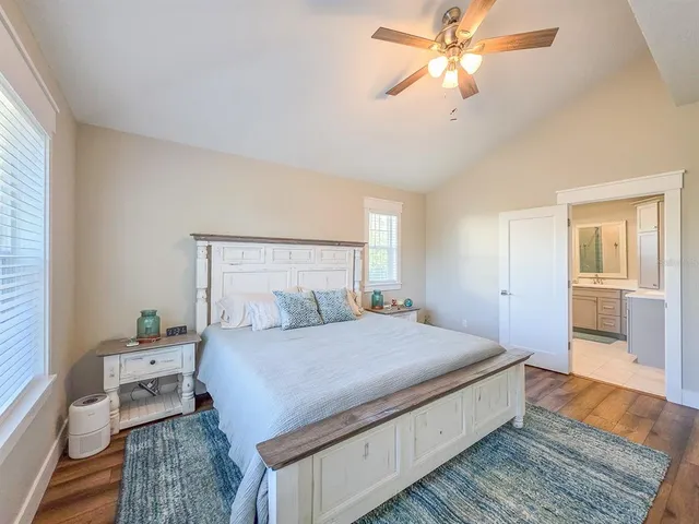 a bedroom with a bed and a chandelier