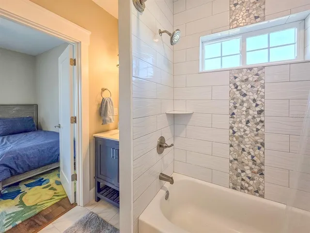 a bedroom with a large bed and a window