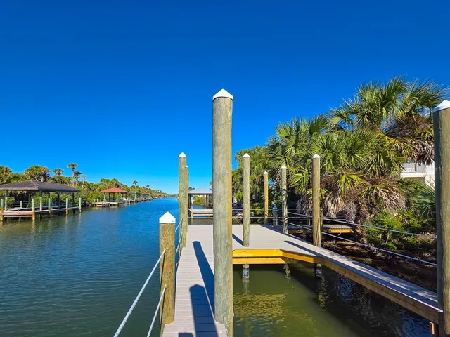 a living room with furniture a ceiling fan and a flat screen tv