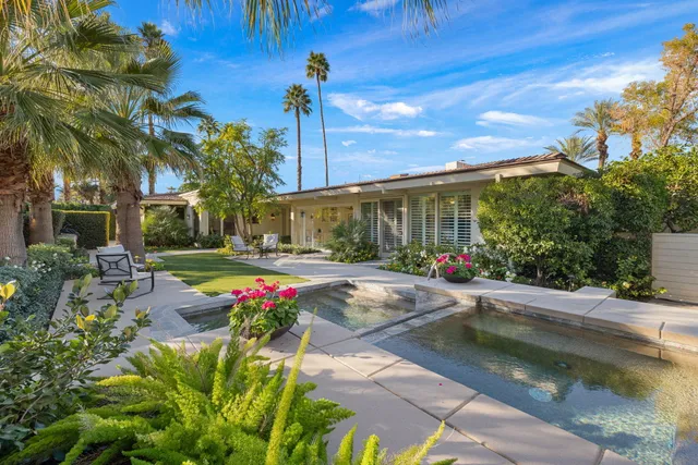 a view of a town with swimming pool and mountains