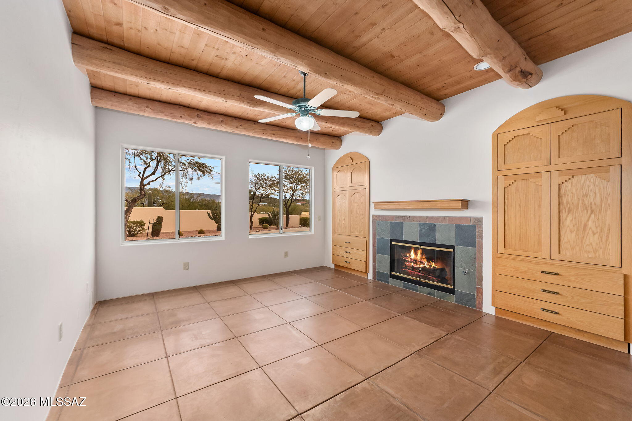 3655 North Harrison Road Tucson, AZ 85749 - Photo 20 of 51 a view of an empty room with a fireplace and a window
