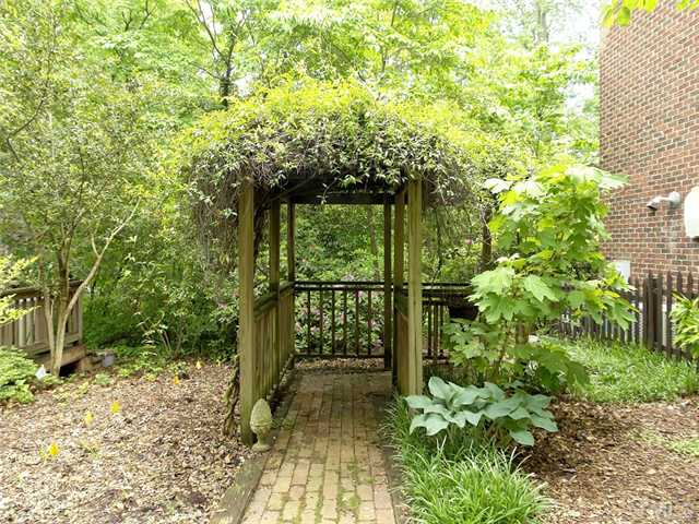 2520 Beechridge Road Raleigh, NC 27608 - Photo 20 of 25 Trellis covered walkway leads to the back yard.