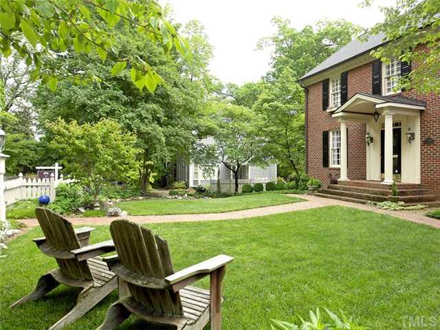 2520 Beechridge Road Raleigh, NC 27608 - Photo 22 of 25 Charming picket fence lines the beautifully landscaped front yard.