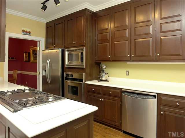2520 Beechridge Road Raleigh, NC 27608 - Photo 7 of 25 Rich mahogany cabinety and stainless steel appliances are outstanding features in the kitchen.