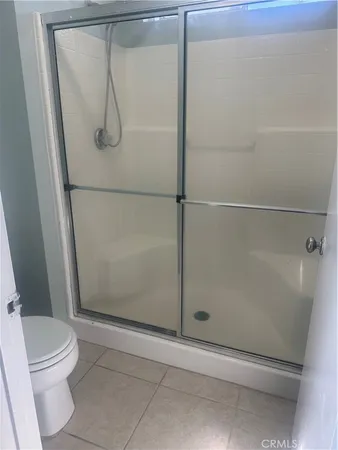 a bathroom with a glass shower door