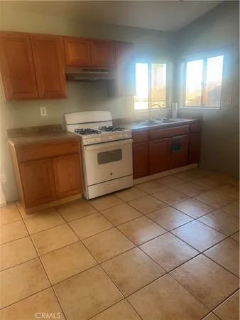 a kitchen with a cabinets and white stove top oven