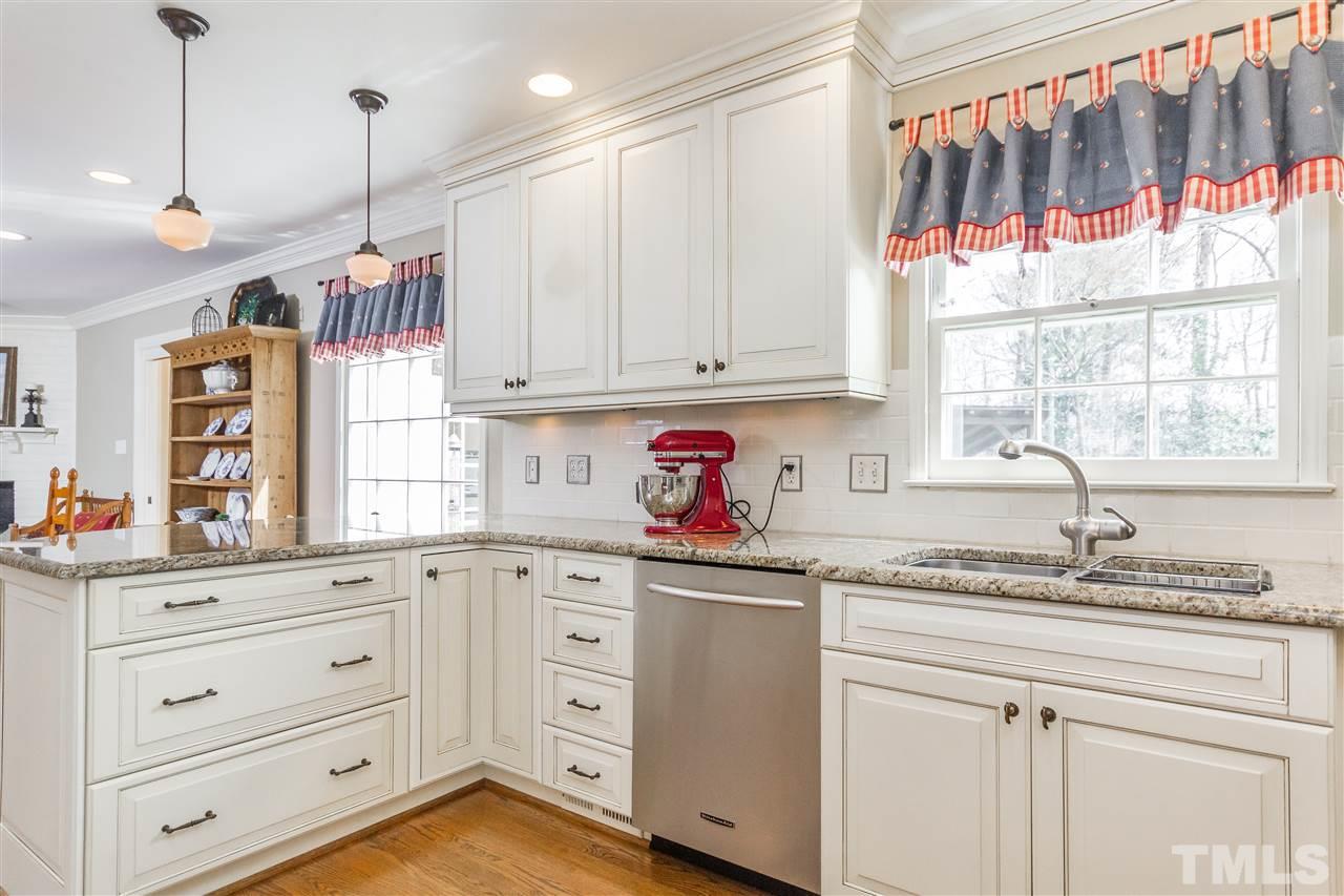 2408 Ridge Road Raleigh, NC 27612 - Photo 11 of 25 a kitchen with granite countertop white cabinets and white appliances